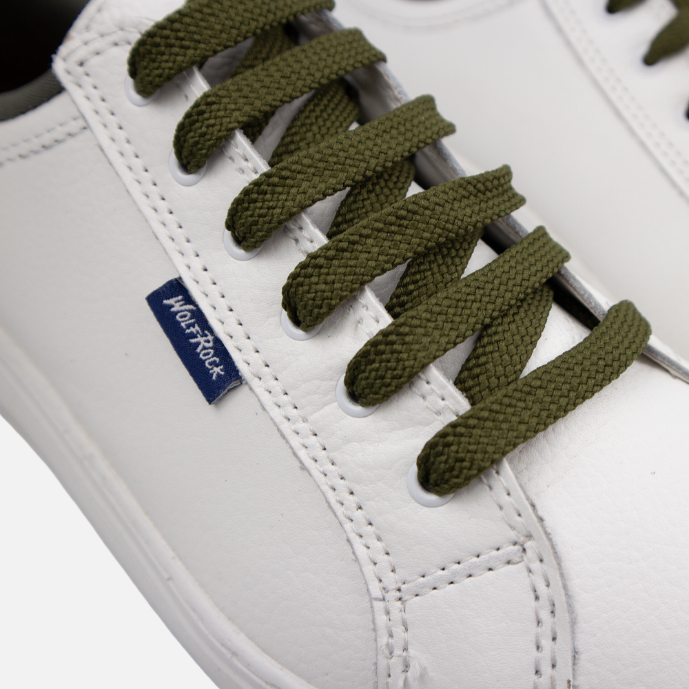 Close up detail of white pebble leather texture and olive green laces.
