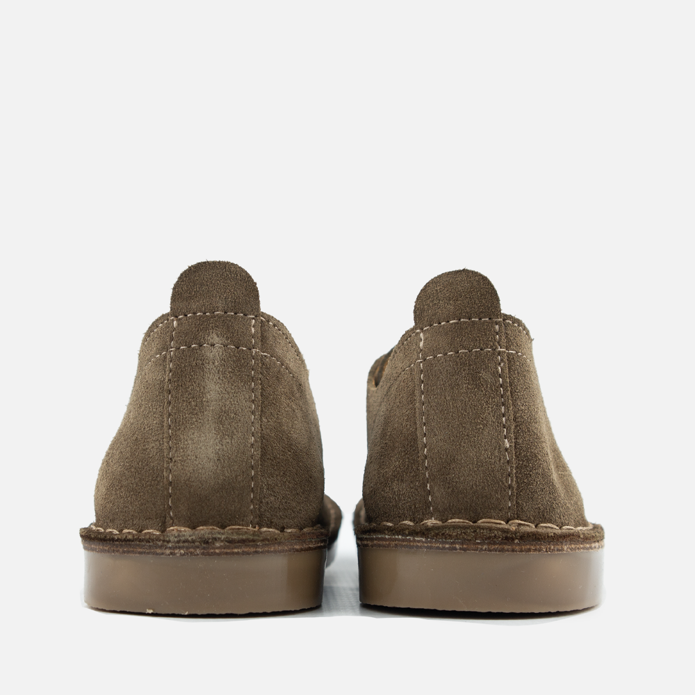 A pair of olive-green Dillon shoes shown from the back, featuring contrast stitching and a brown rubber sole.
