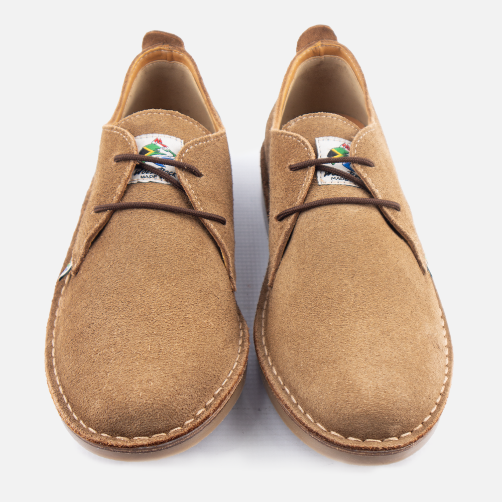A pair of Wolf Rock Made in ZA shoes in donkey suede photographed from above on a light gray background.