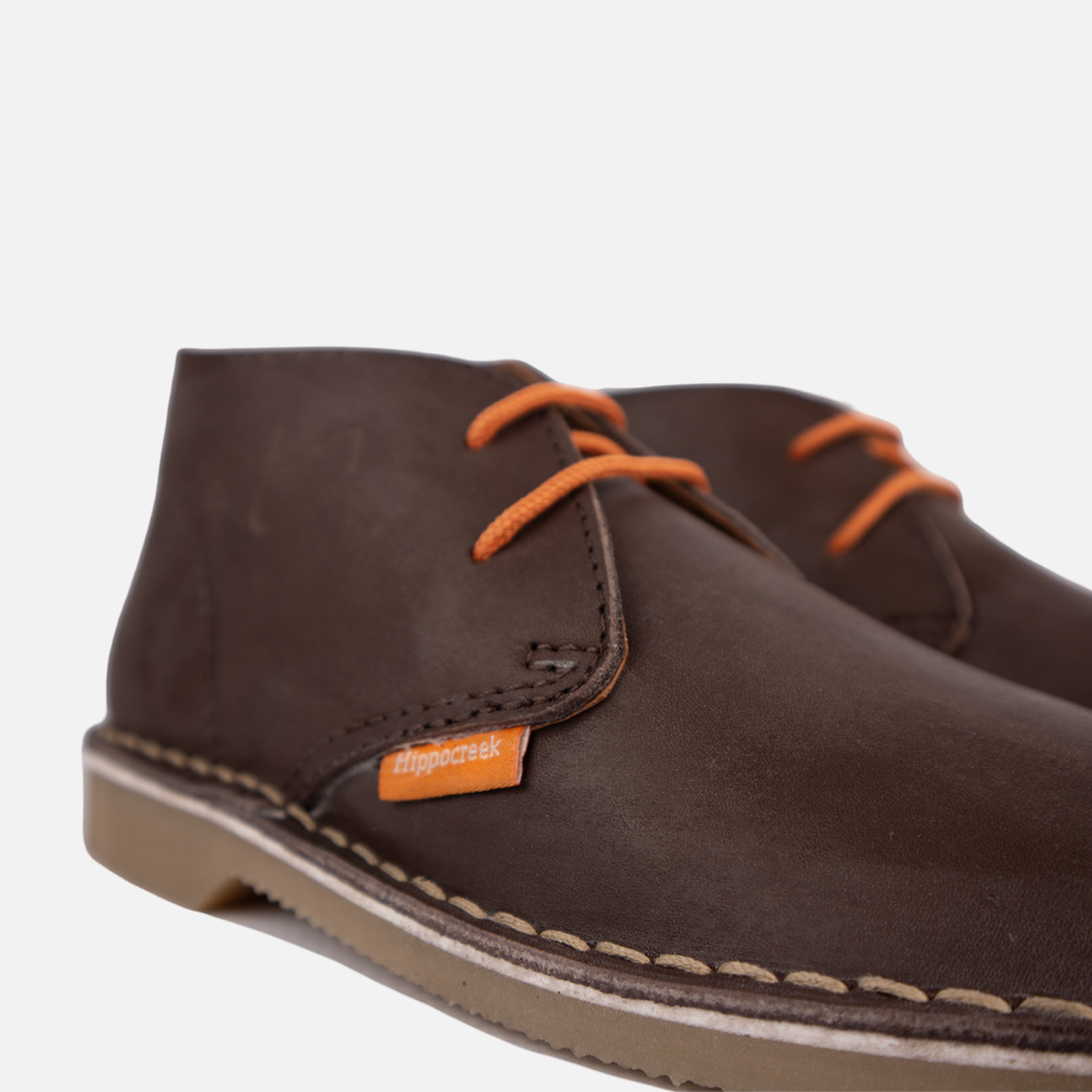 Close-up view of the sturdy lace-up closure and high-quality genuine leather of the HippoCreek Youths Lemur Mid Boot.