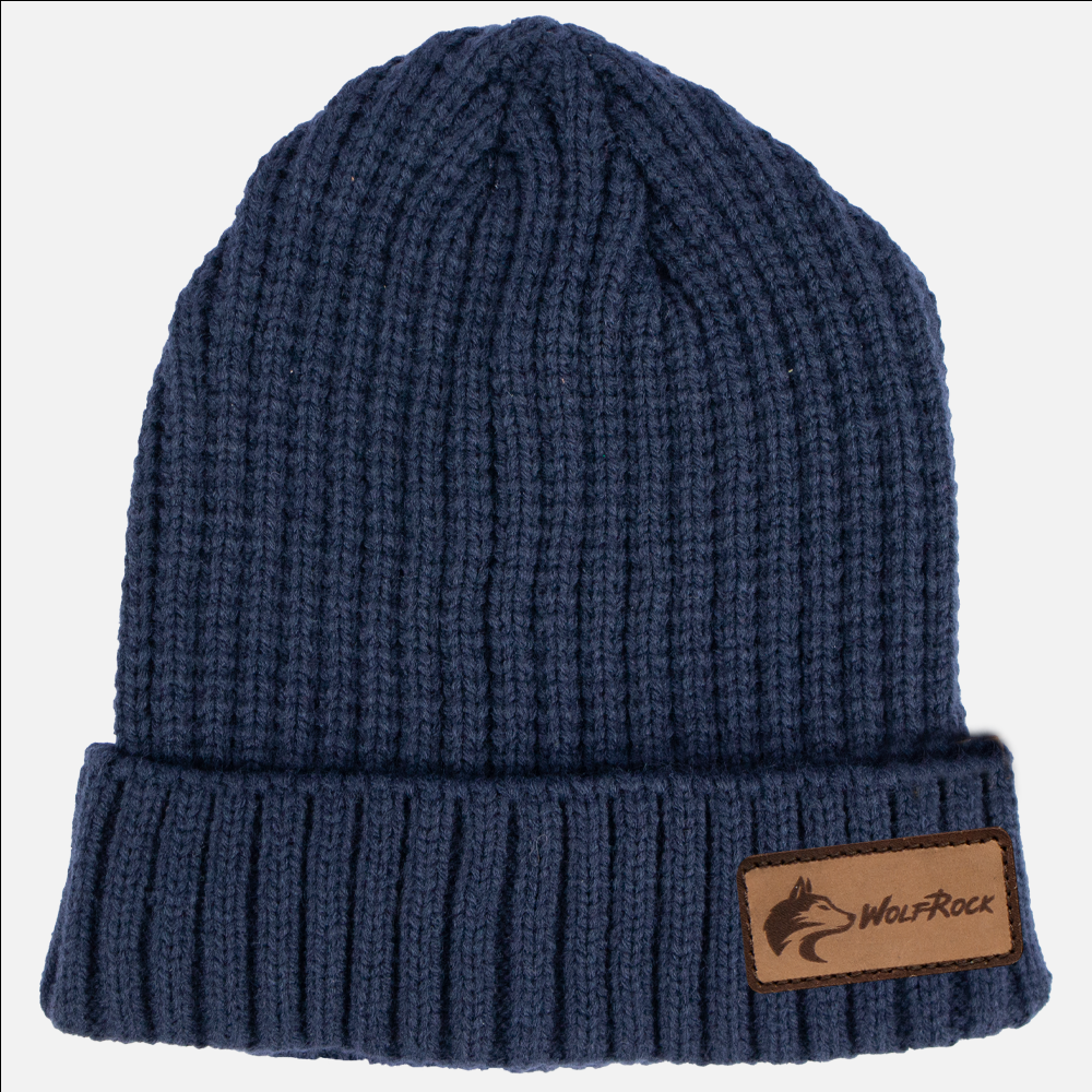 A navy blue knitted beanie with a leather brand patch on the side, featuring the Wolf Rock brand.