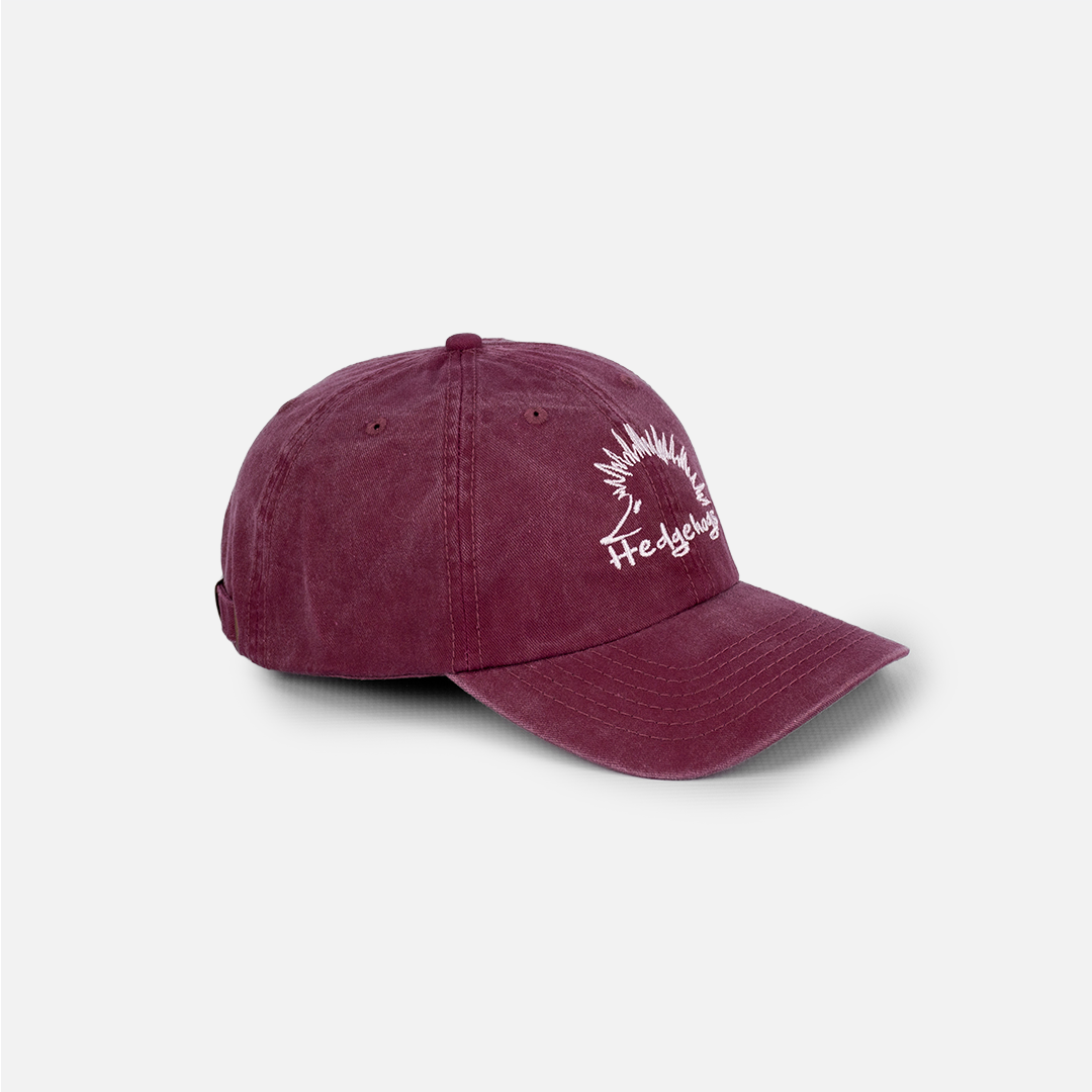 Side profile of the Hedgehogs Burgundy Washed Cotton Cap, showing the relaxed shape.
