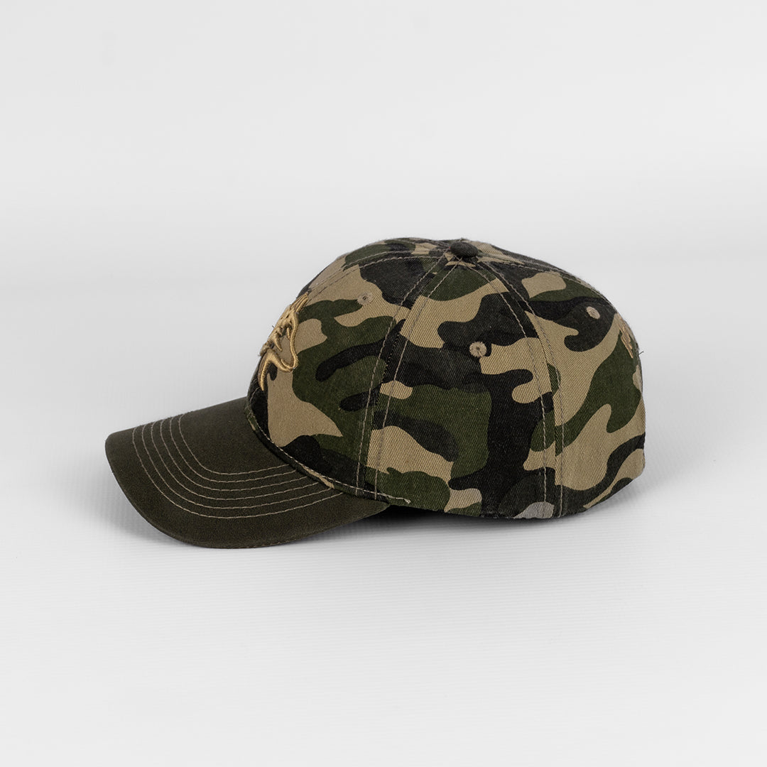 Close-up detail showing the texture difference between the washed cotton and the oil skin components on the camo cap.