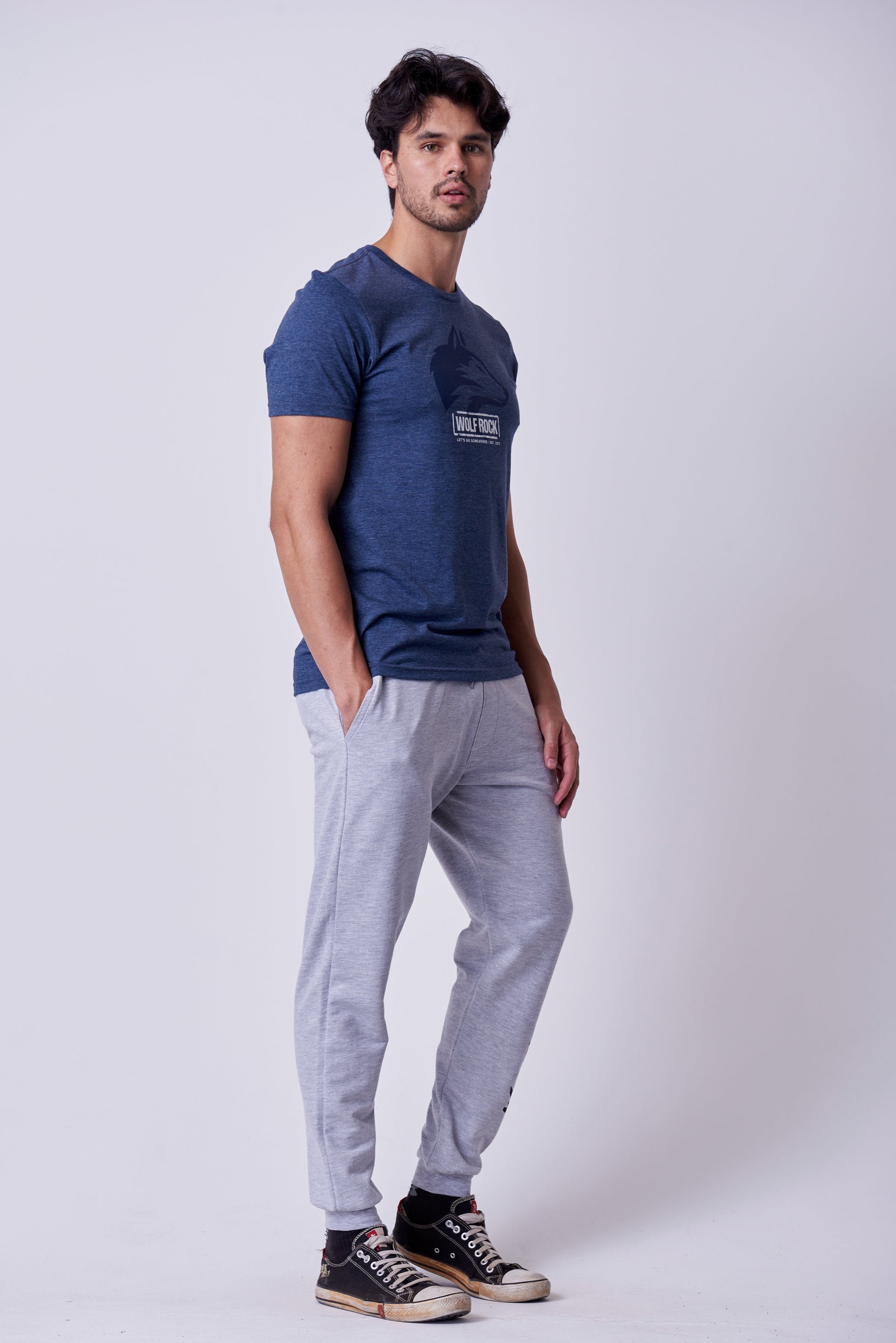 Side view showing the comfortable, tapered fit of the Grey Mélange fleece jogger bottoms.