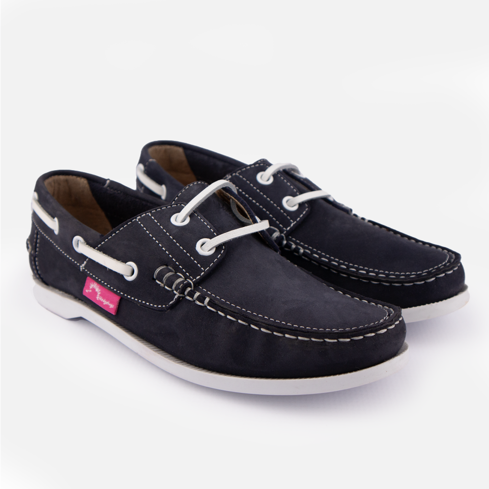 A pair of Hedgehogs Bianca ladies boat shoe in navy nubuck, showing the contrast stitching and lace detail.