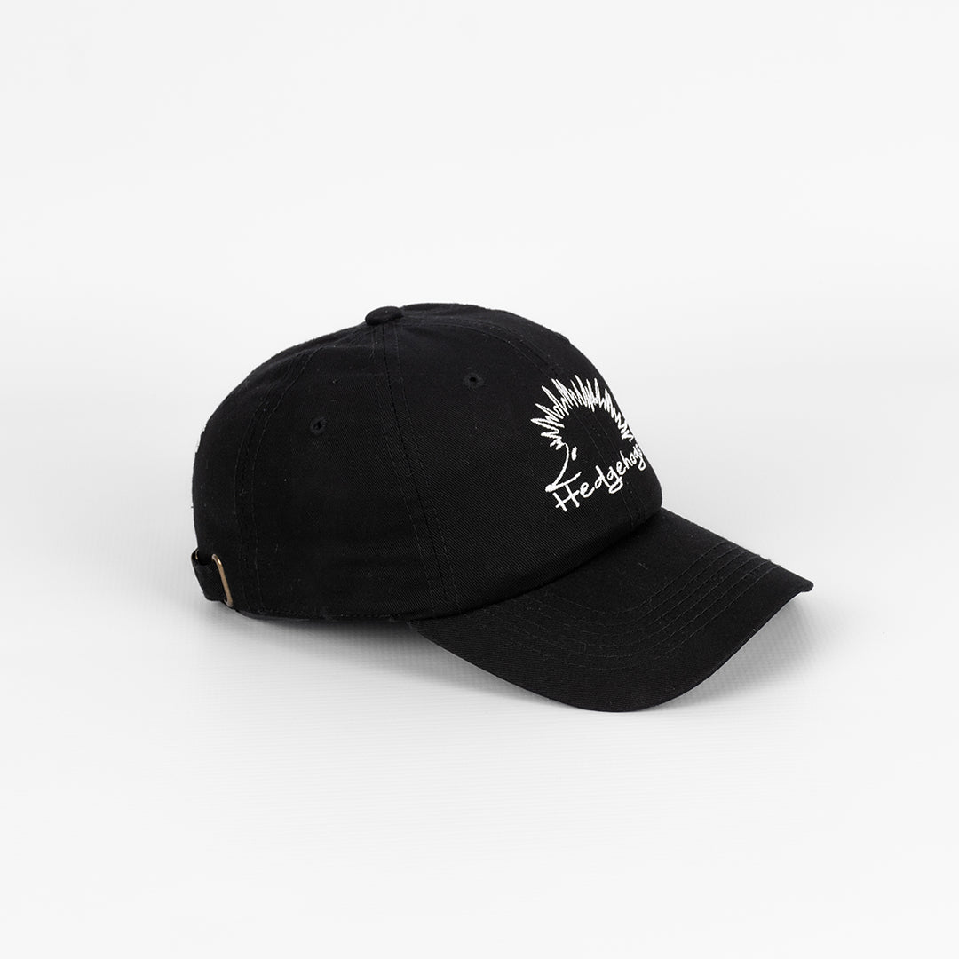Side profile of the Hedgehogs Black Cotton Twill Cap, showing the structured shape.