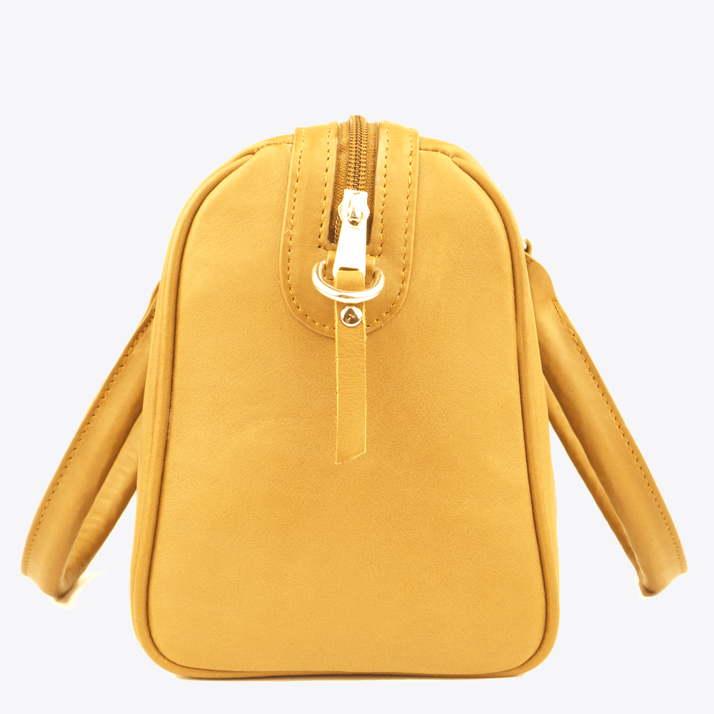 Side view of the Hedgehogs bowler handbag in ochre leather showing zipper detail. 