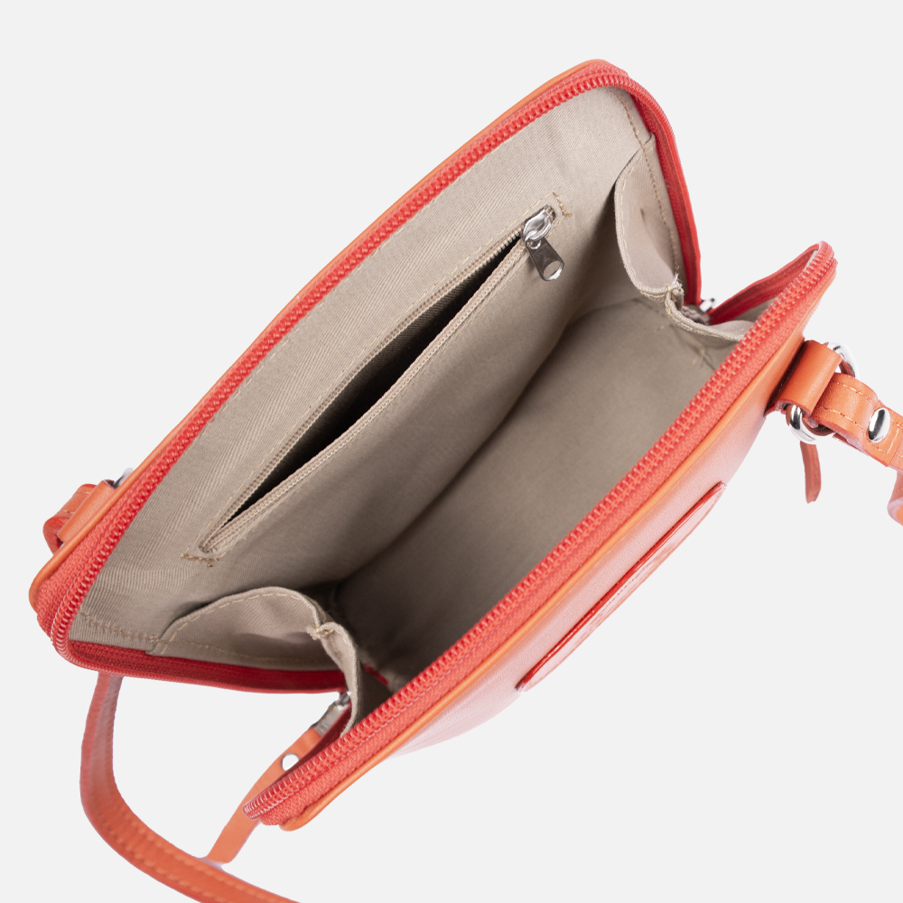 Inside view of the Hedgehogs Coral Leather clutch bag showing internal pocket and zip detail. 