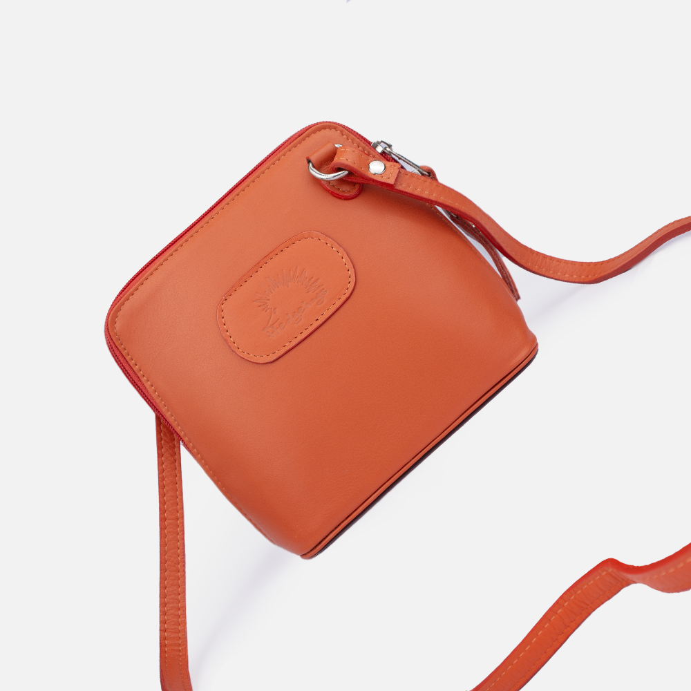 Image of the Hedgehogs coral cloth bag showing the crossbody leather strap.