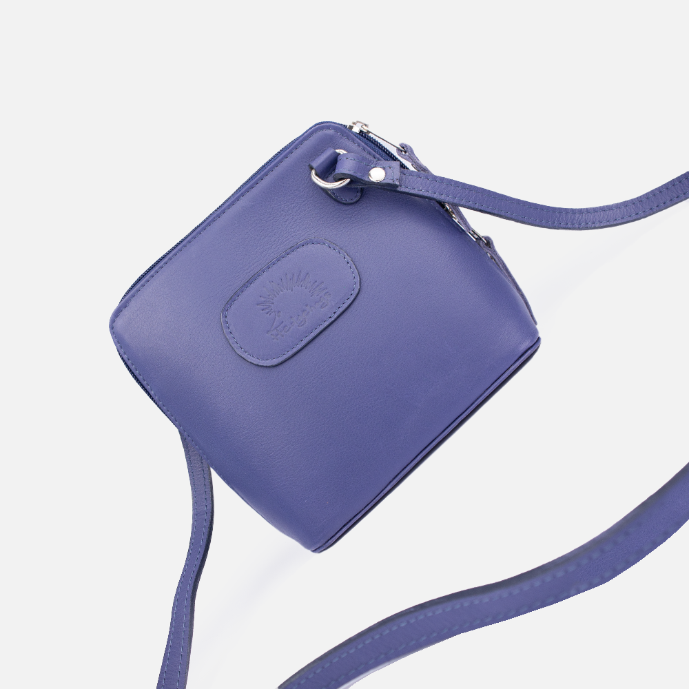 View of the Hedgehogs clutch bag in Indigo leather showing the crossbody strap and front logo embossing 