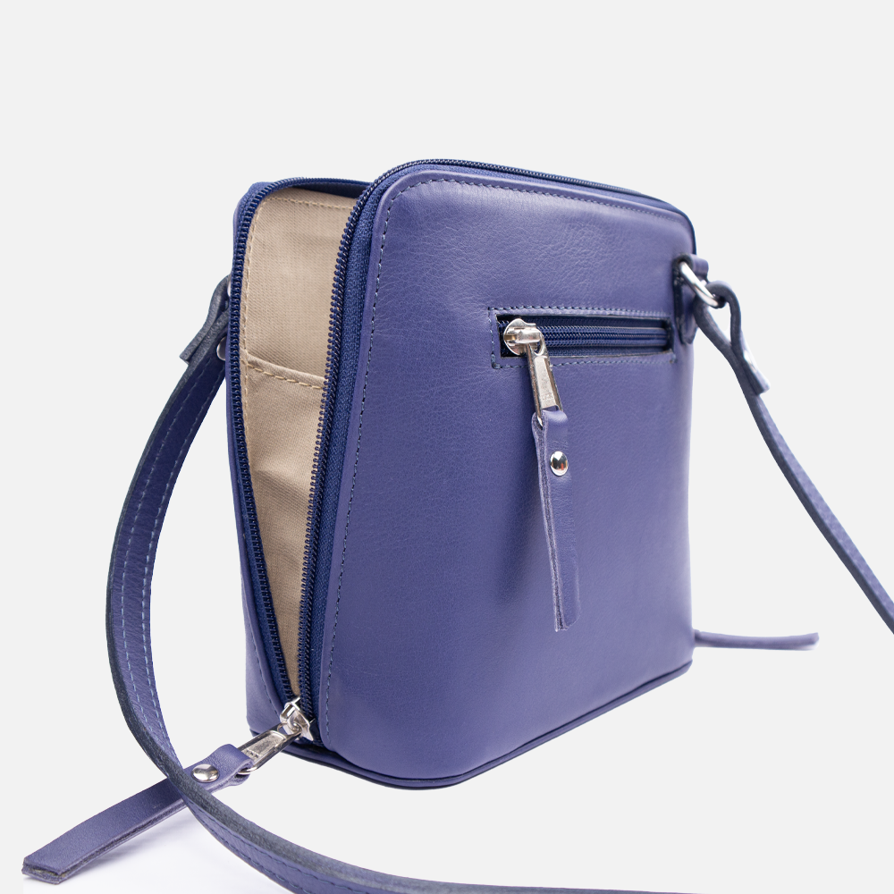 Side view of the Hedgehogs clutch bag in indigo leather, showing the lining gusset, strap detail and external pocket view