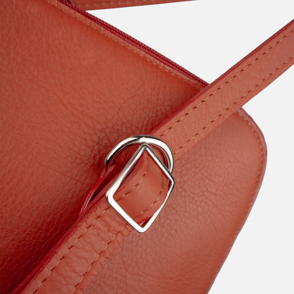 Close up view of the buckles on the Hedgehogs ladies convertible backpack in vibrant coral leather