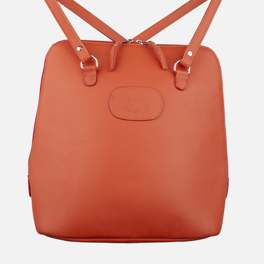 Primary view of the Hedgehogs ladies convertible backpack in vibrant coral leather, showing the front logo embossing and strap detail. 