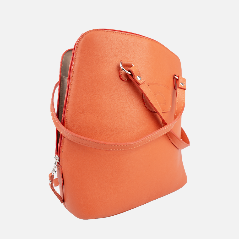 Side view of the Hedgehogs ladies convertible backpack in coral leather, showing zipper and strap detail.