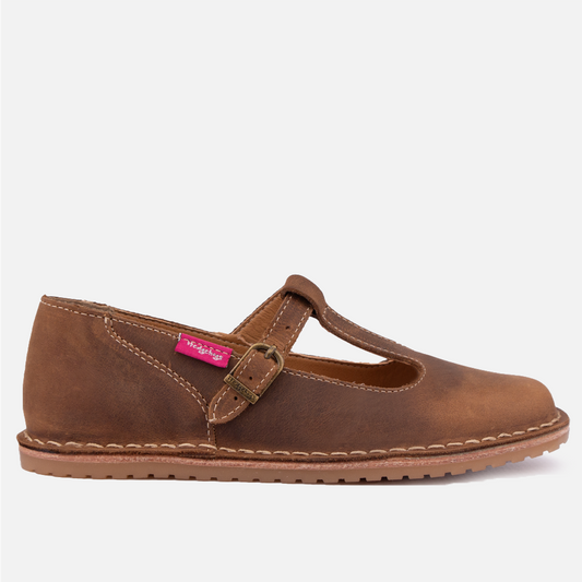 Side profile of the Hedgehogs Kylie Shoe, a flat, t-bar style women's shoe with a brass buckle. 