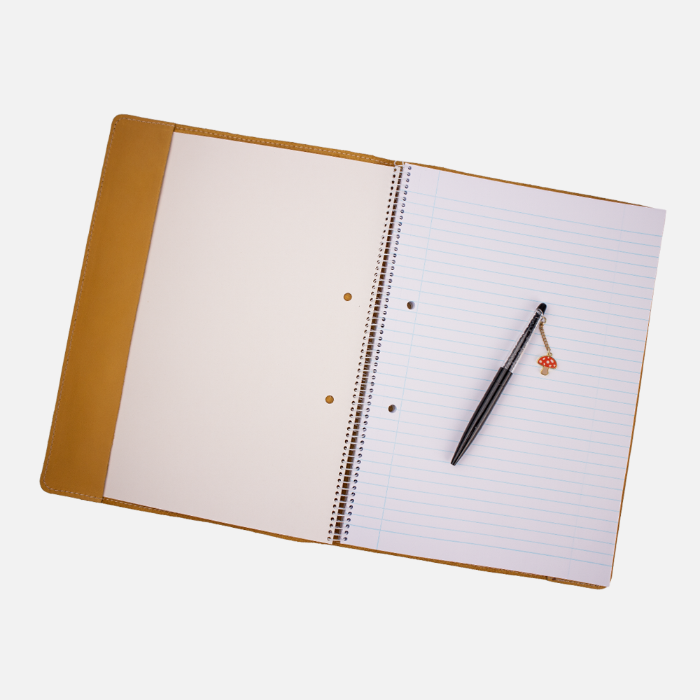 View of the Hedgehogs full grain leather A4 notebook cover in ochre yellow leather, showing the fit of a notebook. 
