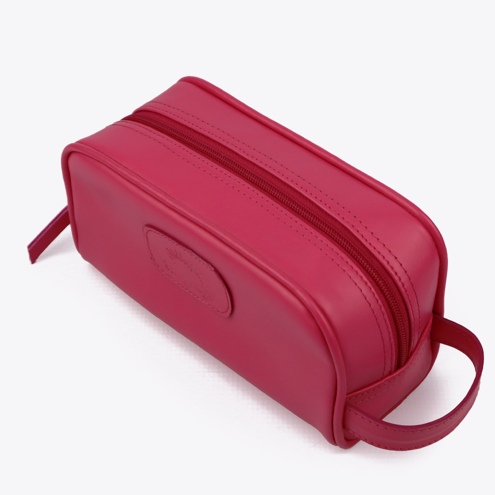 Top view of the Hedgehogs ladies toiletry bag in cerise pink leather, showing the zip closure. 