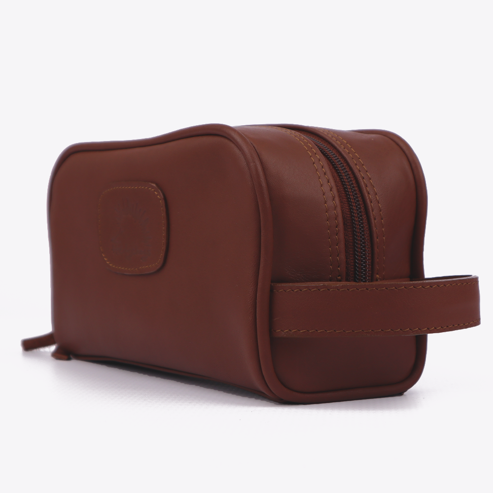 Side view of the Hedgehogs ladies toiletry bag in chocolate brown leather, showing side hand loop strap.