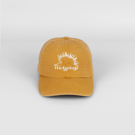 Front view of the Hedgehogs Washed Cotton Cap in Mustard featuring subtle front logo embroidery.