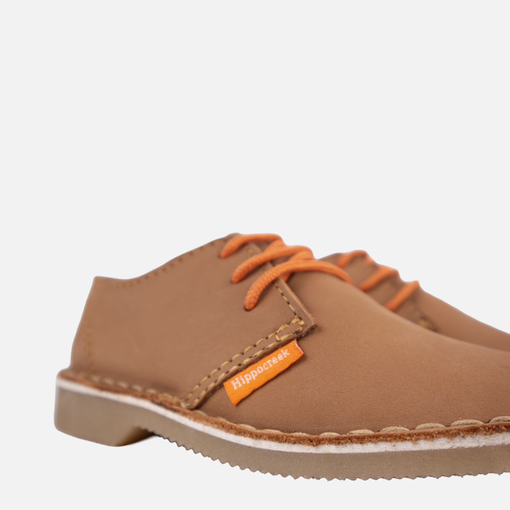 Close-up detail of the lace-up closure and genuine leather material on the HippoCreek Kids Jackal Shoe.