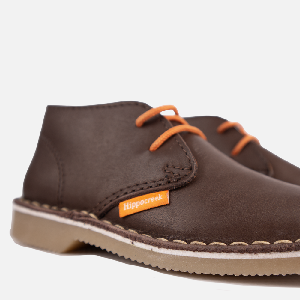 Close-up view of the sturdy lace-up closure and high-quality chocolate leather of the HippoCreek Kids Lemur Mid Boot.