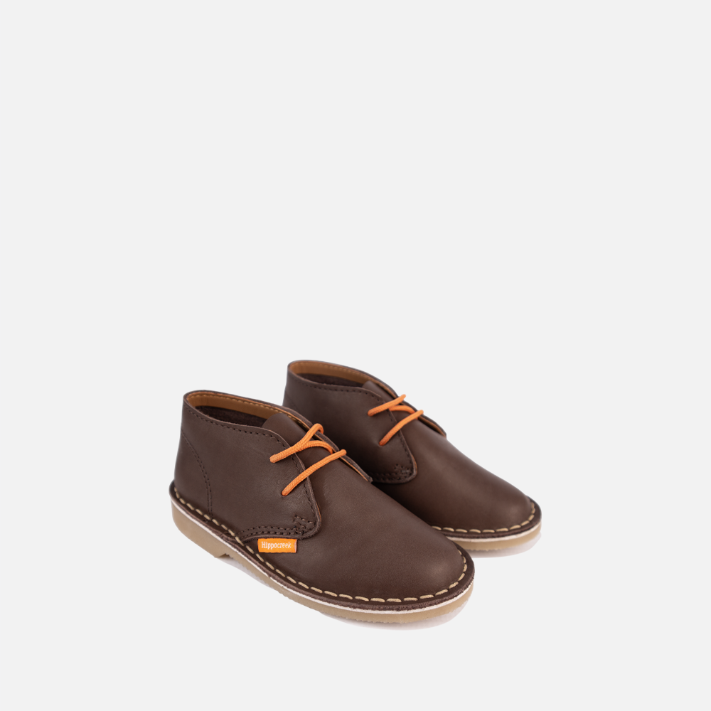 Pair of chocolate brown full-grain leather HippoCreek kids Lemur mid-boot with orange laces.