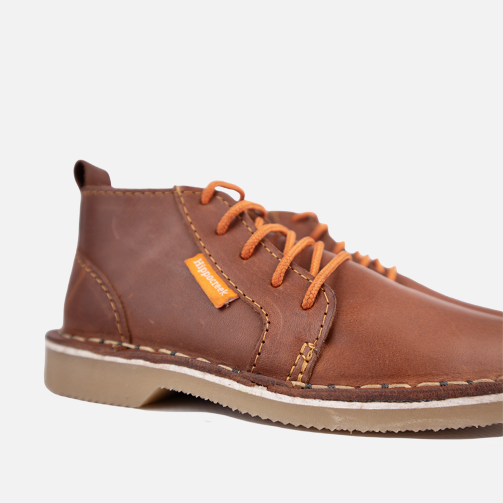 Close-up view of the sturdy lace-up closure and high-quality Cognac leather of the HippoCreek Kids Owl Leather Boot.