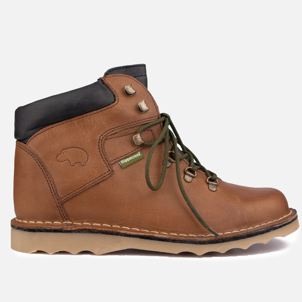 Side profile of the HippoCreek Pangolin Boot, a men's heavy-duty leather boot in Donkey tan leather featuring the mud-shedding Wave Sole.