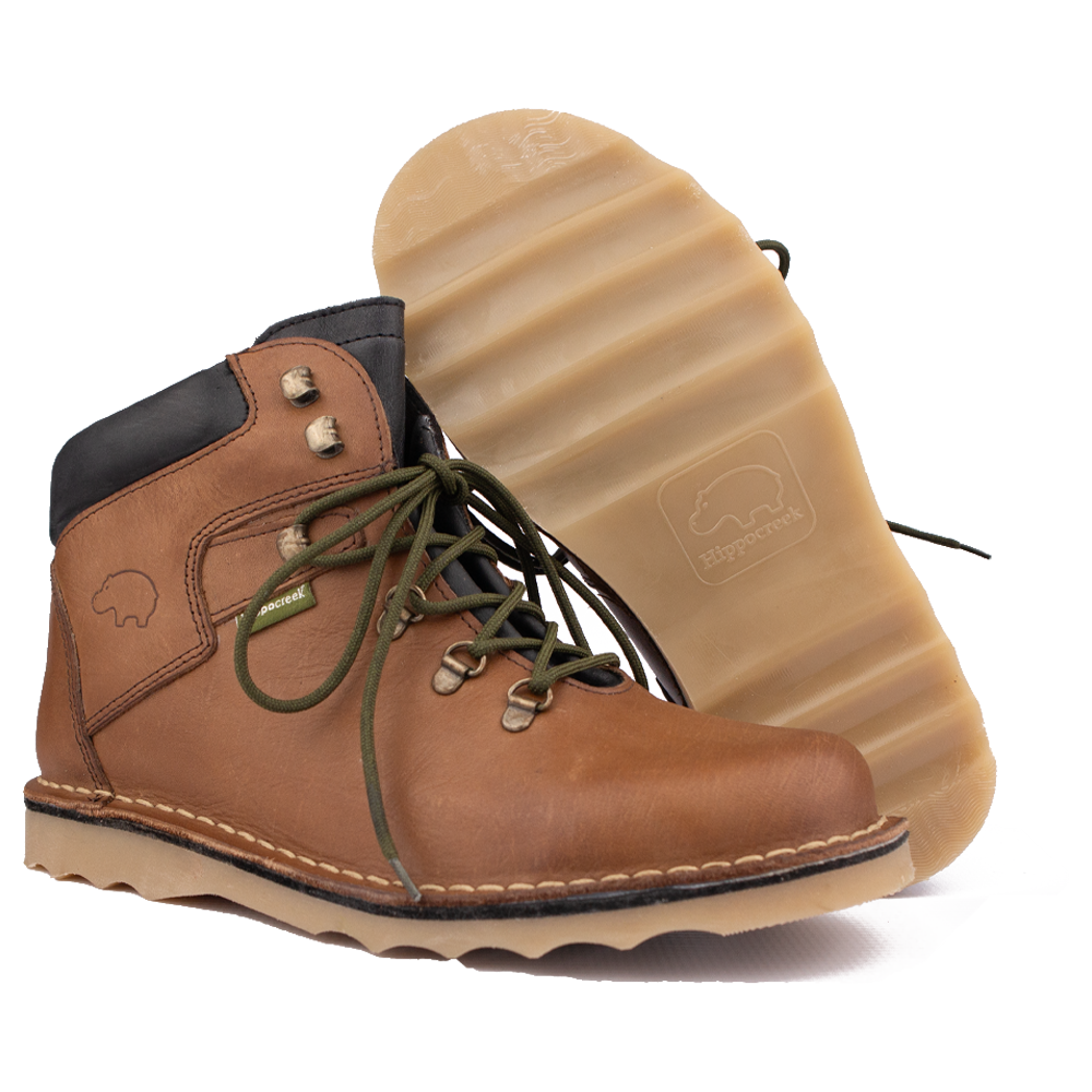 Close-up of the aggressive, undulating HippoCreek Wave Sole tread, emphasizing its mud-shedding utility.