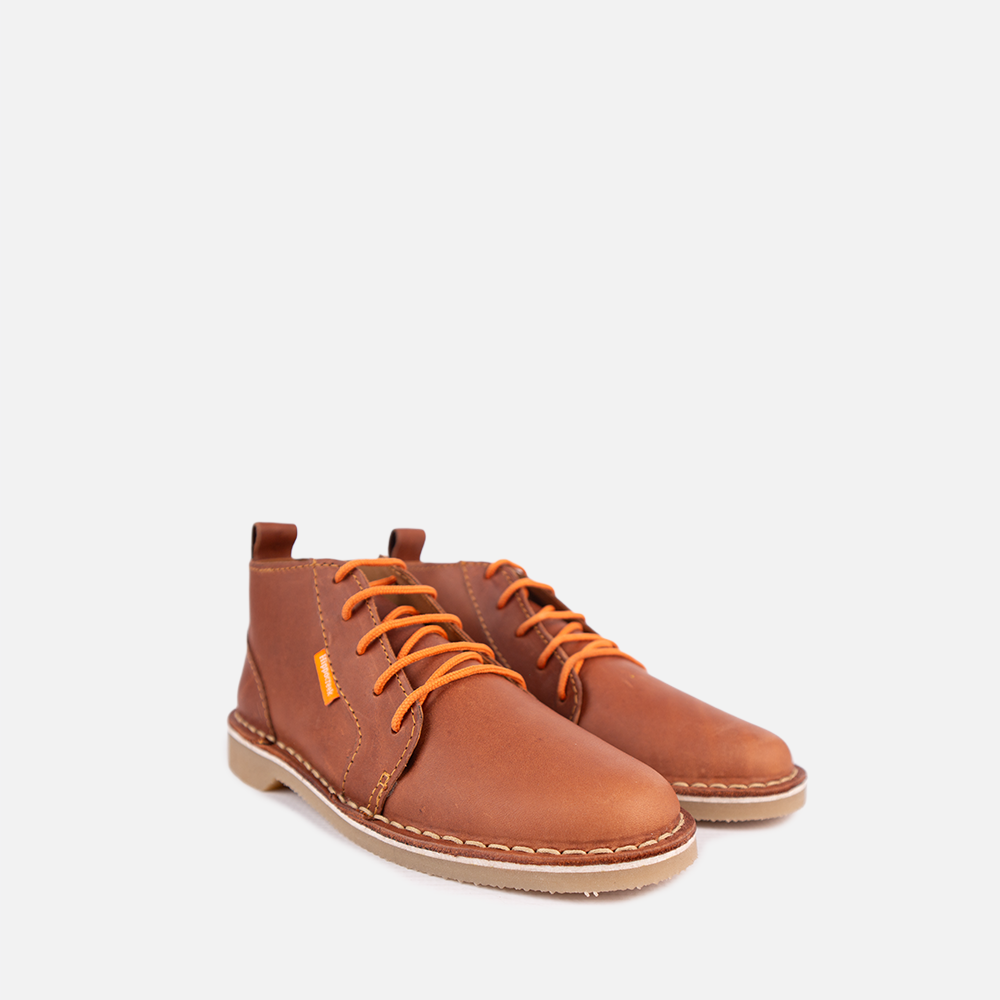 Side view of a pair of Cognac full-grain leather HippoCreek Youths Owl Boot.