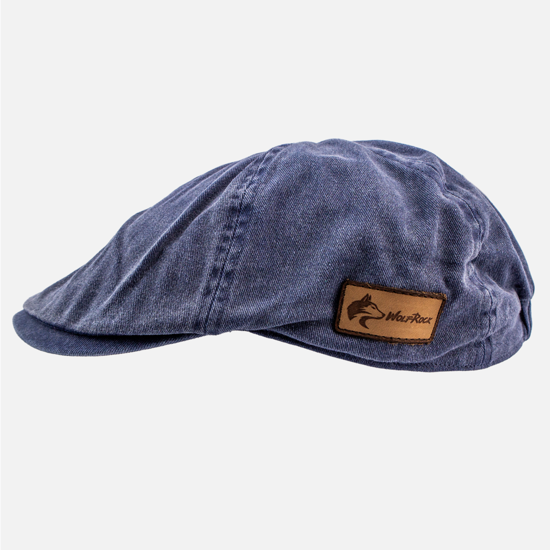 Alternate side view of the Wolf Rock Navy blue Cotton Flat Cap, showing the branded leather side patch. 