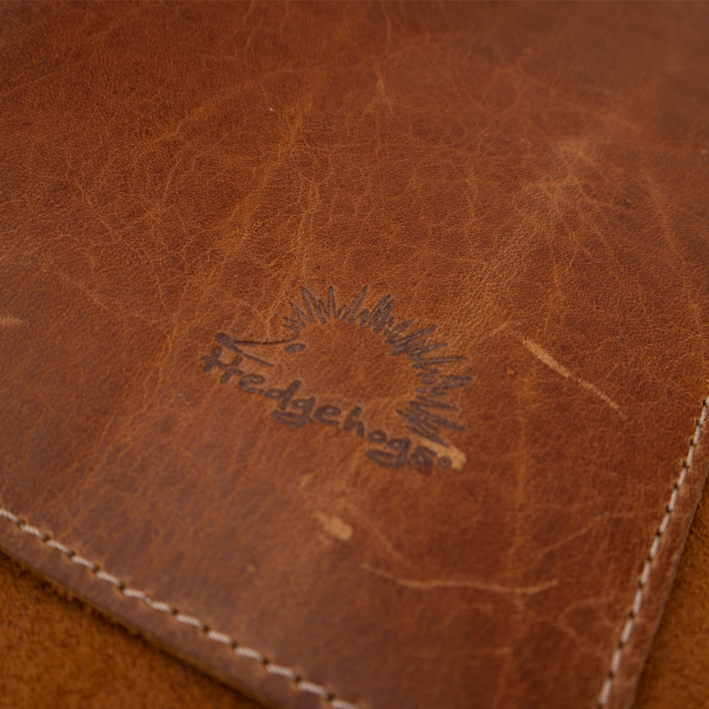 Close-up texture of the supple, full-grain Tan leather.