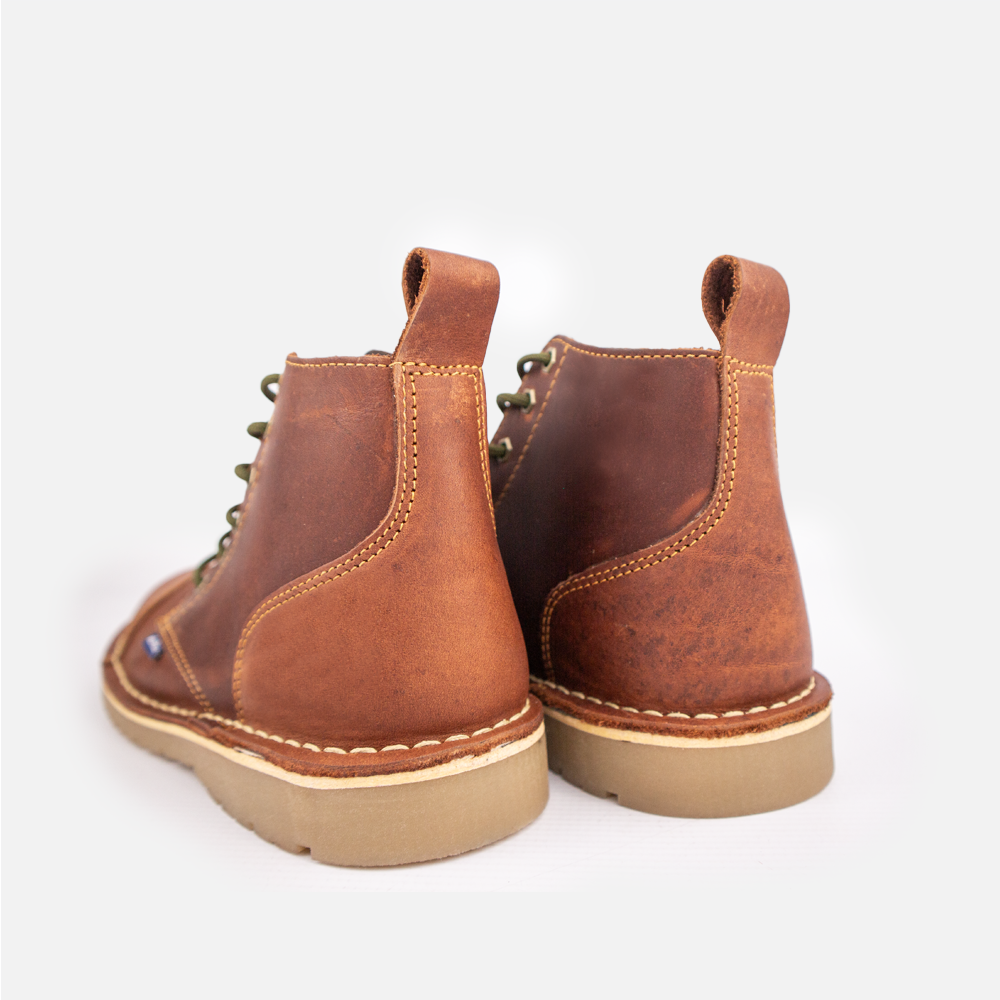 Rear view of a pair of Wolf Rock Baxter boots in. rich cognac leather, showing contrast stitching up the heel and heel pull tab.