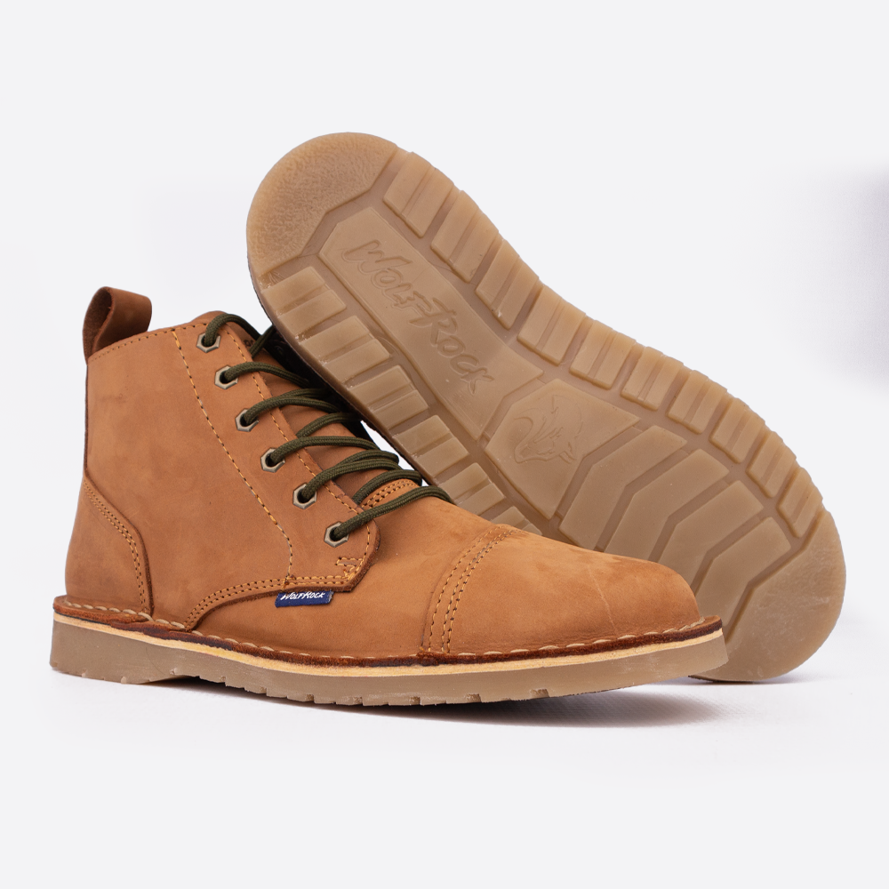 A pair of Wolf Rock Baxter traditional chukka-style boots showing the branded sole detail.