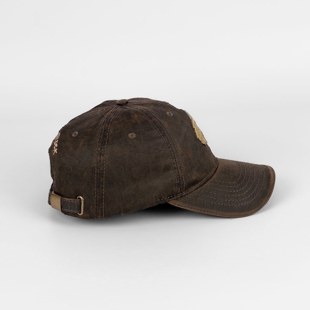 Side profile of the Brown Oil Skin Cap showing the peak and crown shape.