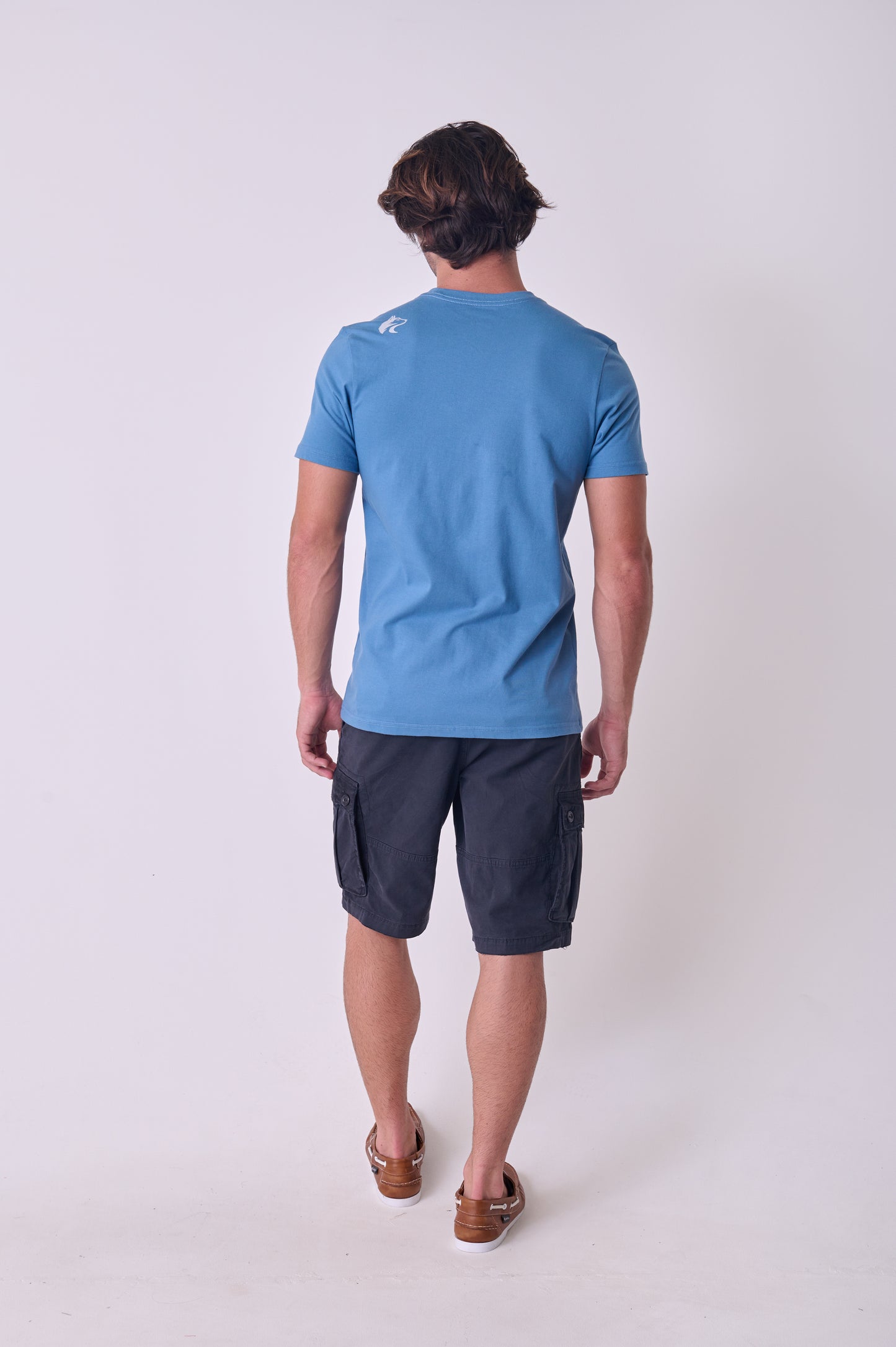 Rear view of the Wolf Rock Let's Go Tee in Petrol Blue with a dynamic adventure graphic print.