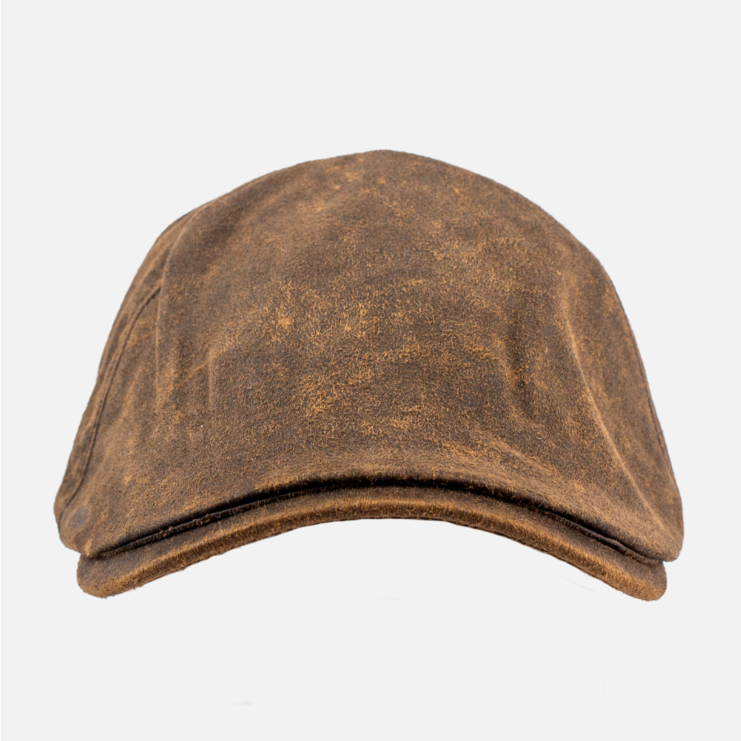 Front view of the Wolf Rock Oilskin Flat Cap, showing the dark, waxed finish.