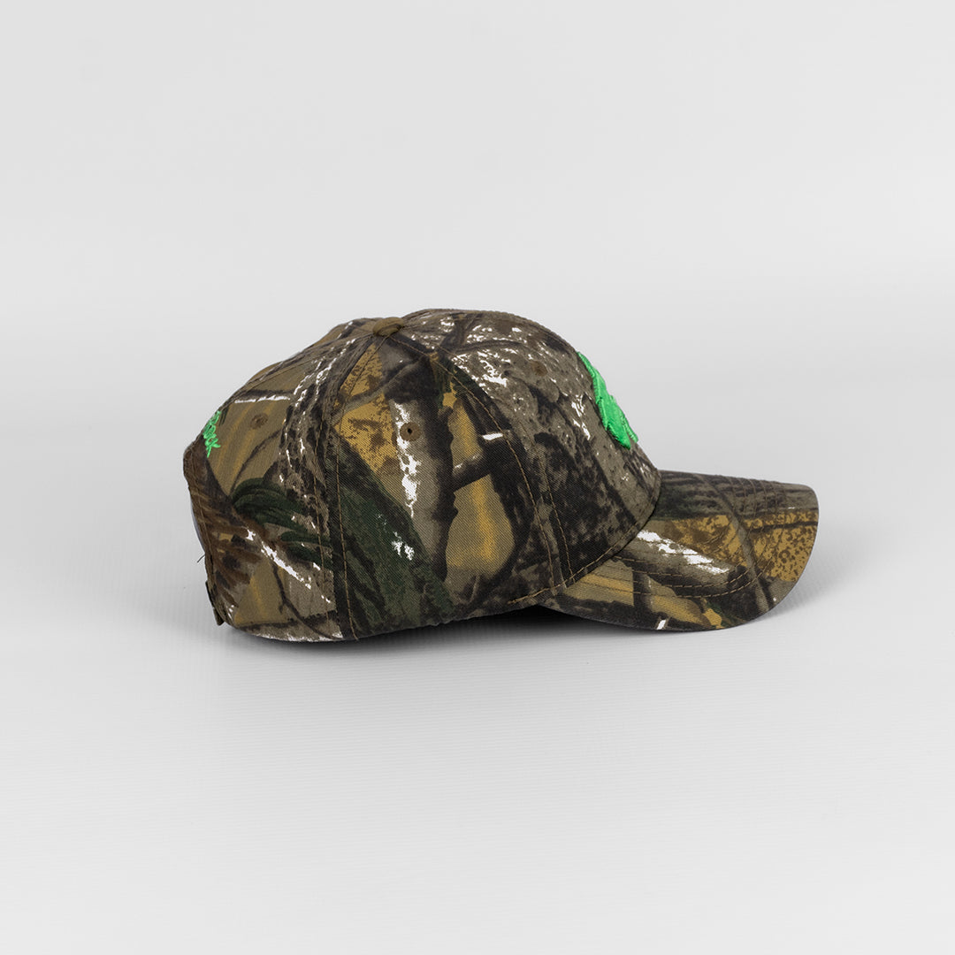 Alternate Side profile of the Cotton Pine Camo Cap showing the pine woodland-inspired camo print. 