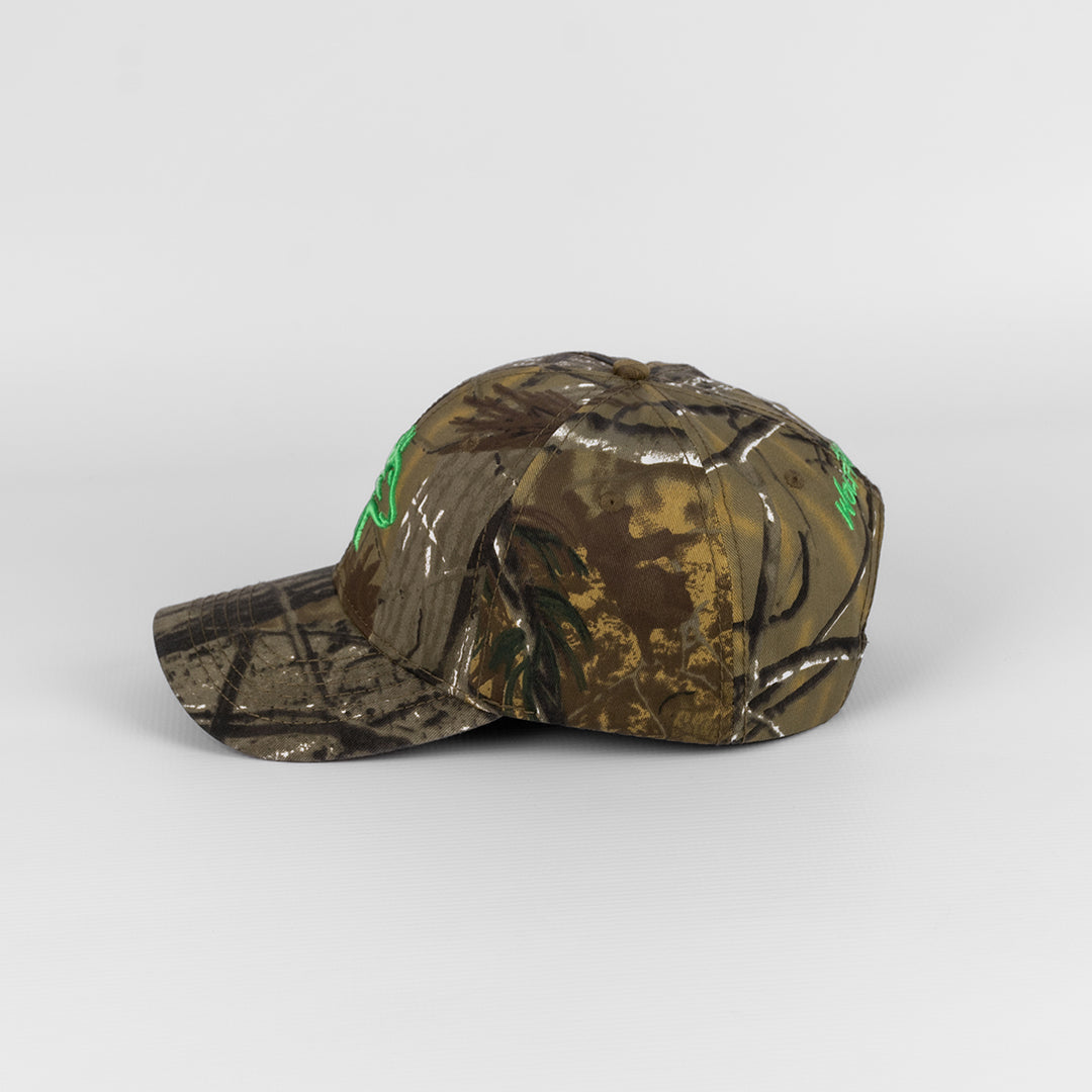 Alternate side profile of the Wolf Rock Cotton Pine Camo Cap showing the peak and crown shape.