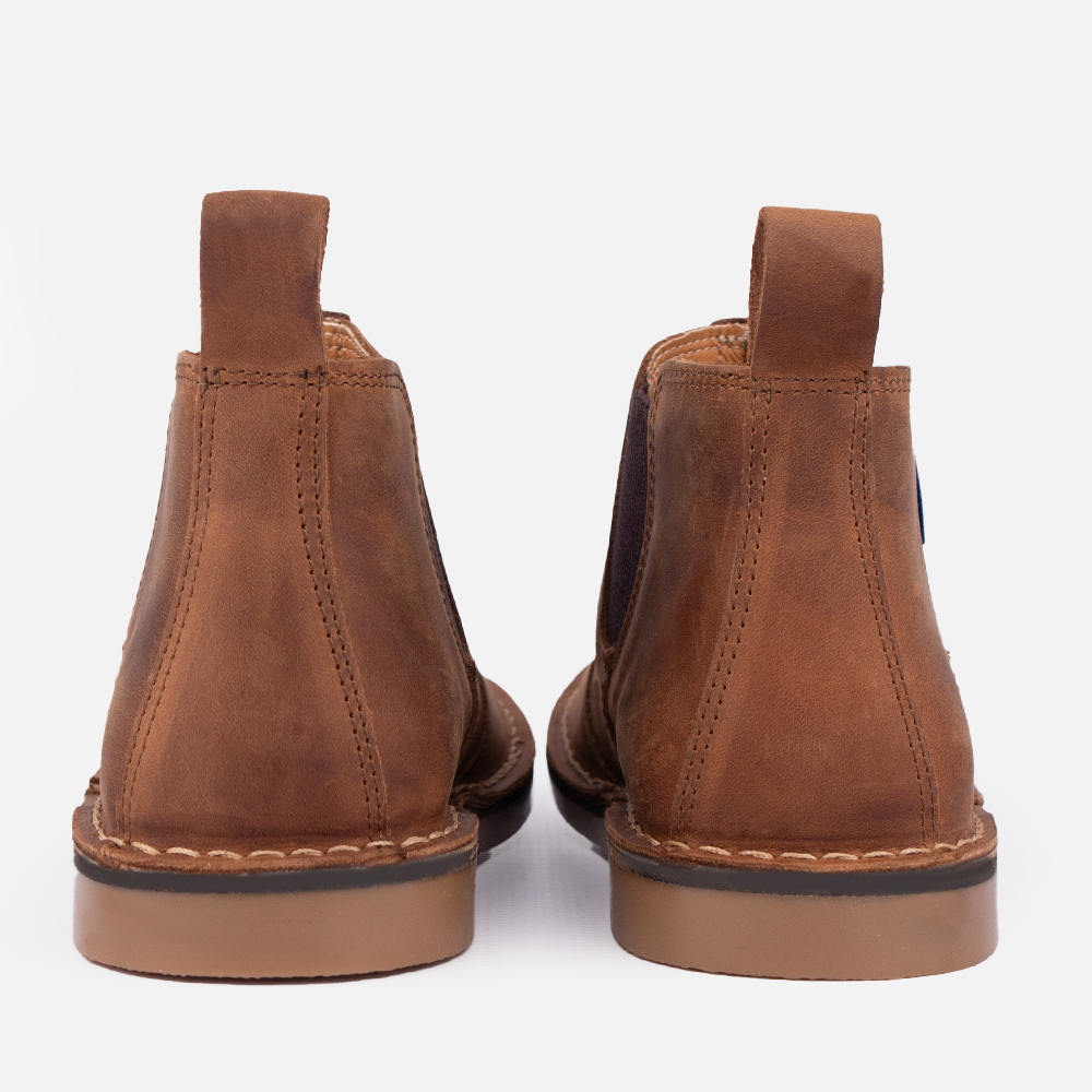 Heel view of a pair of Wolf Rock Timber Mid-Boot in Santiago Dark Choc full-grain leather, a men's casual slip-on gusset boot.